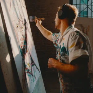 an artist painting a large canvas