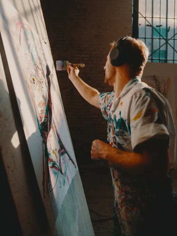 an artist painting a large canvas